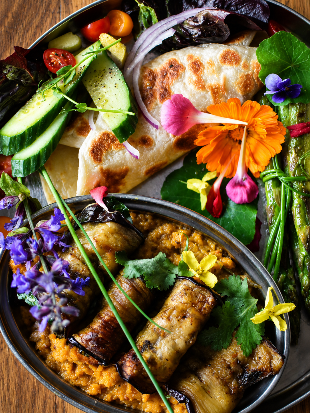 A colourful vegetarian feast with vegetables and edible flowers